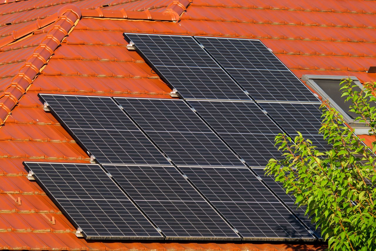 hero-img-01 Close-up of solar panels on a red tiled roof in Croatia, highlighting renewable energy.